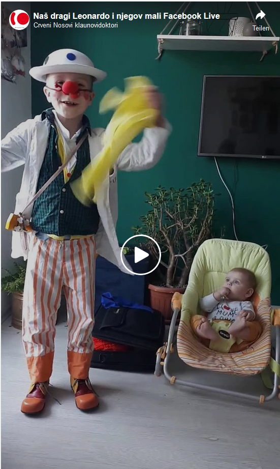 Leo is online performing a small clown show and his baby brother is next to him in the room watching him closely.