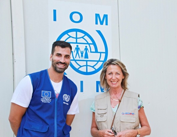 Monica Culen, RED NOSES International founder, stands next to an IOM male staff member.